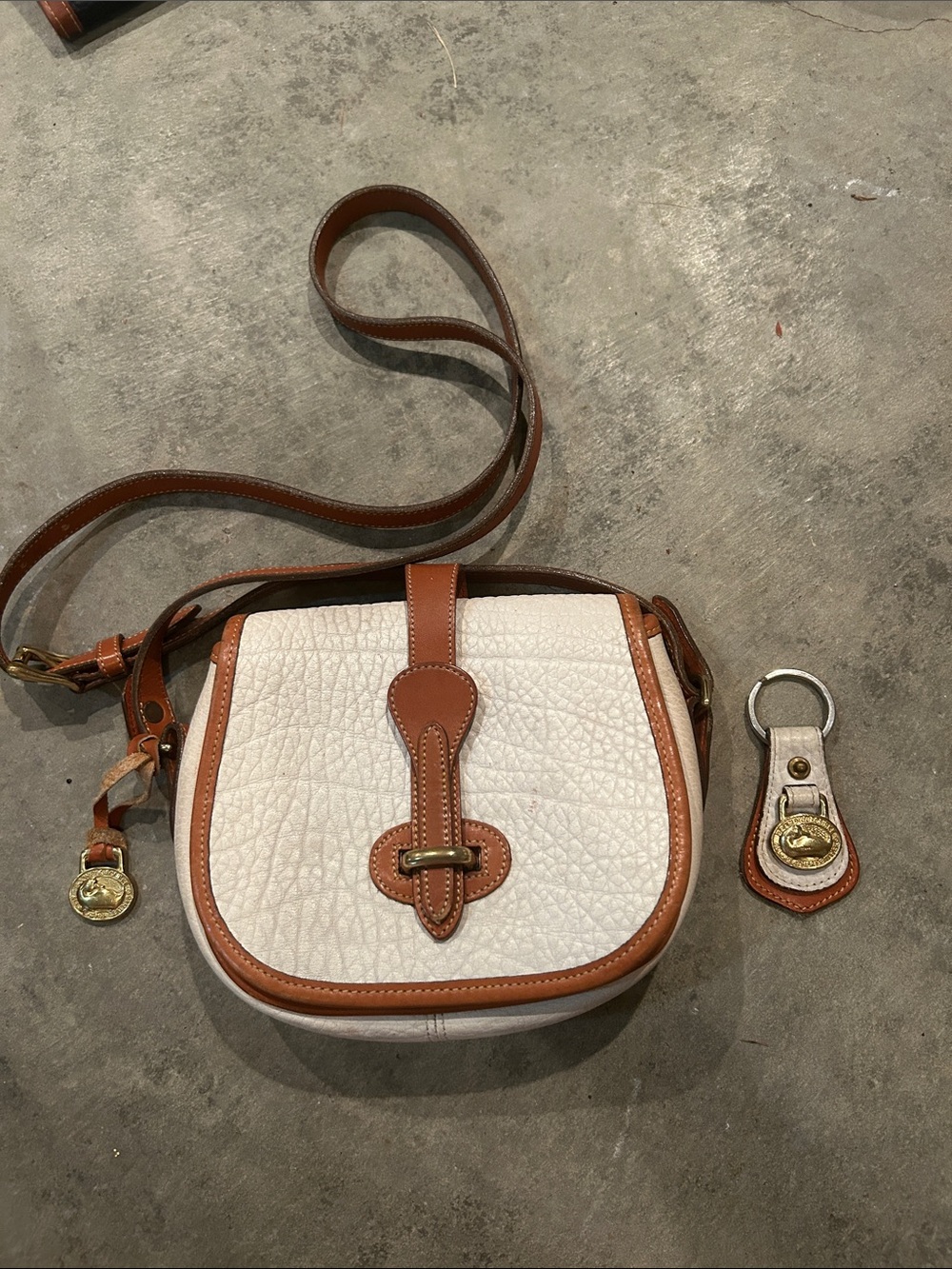 Dooney & Bourke White and Tan Pebbled Leather Crossbody Saddle Bag